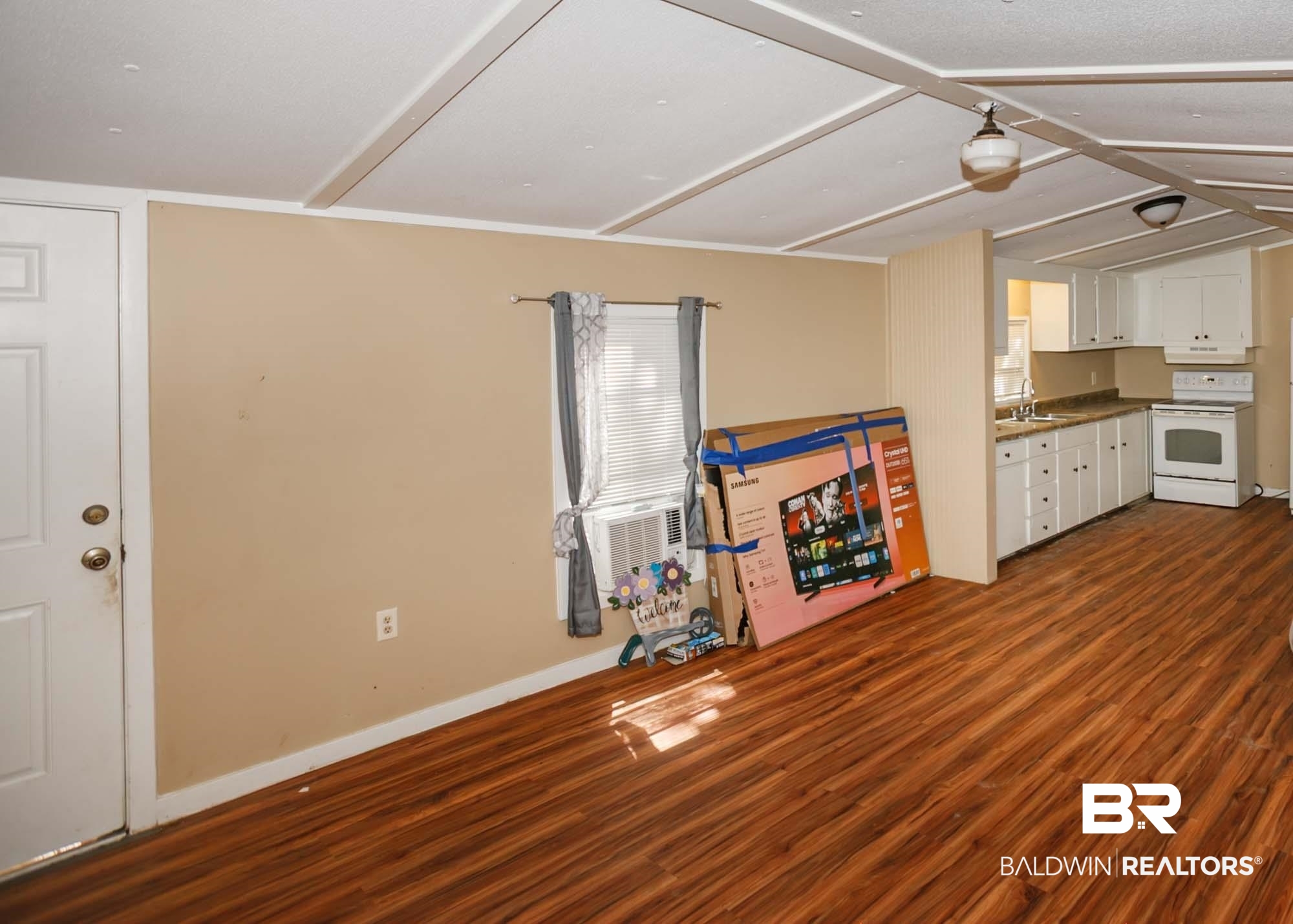 11998 Workman Avenue Foley, AL 36535 - Photo 41 of 59 Unfurnished living room with dark wood-style floors and lofted ceiling