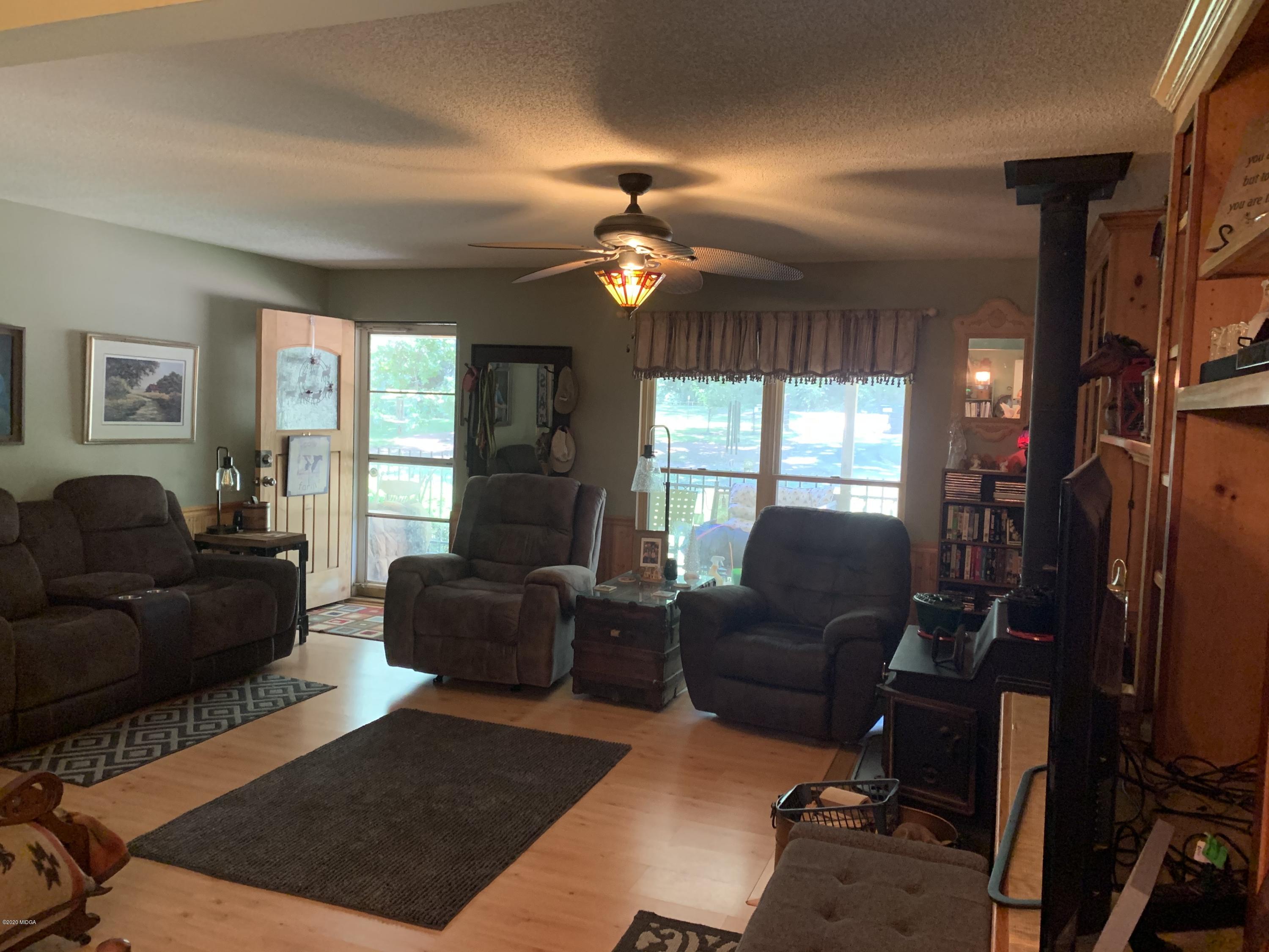 7316 Colaparchee Road Macon, GA 31220 - Photo 5 of 13 a living room with furniture a window and a chandelier