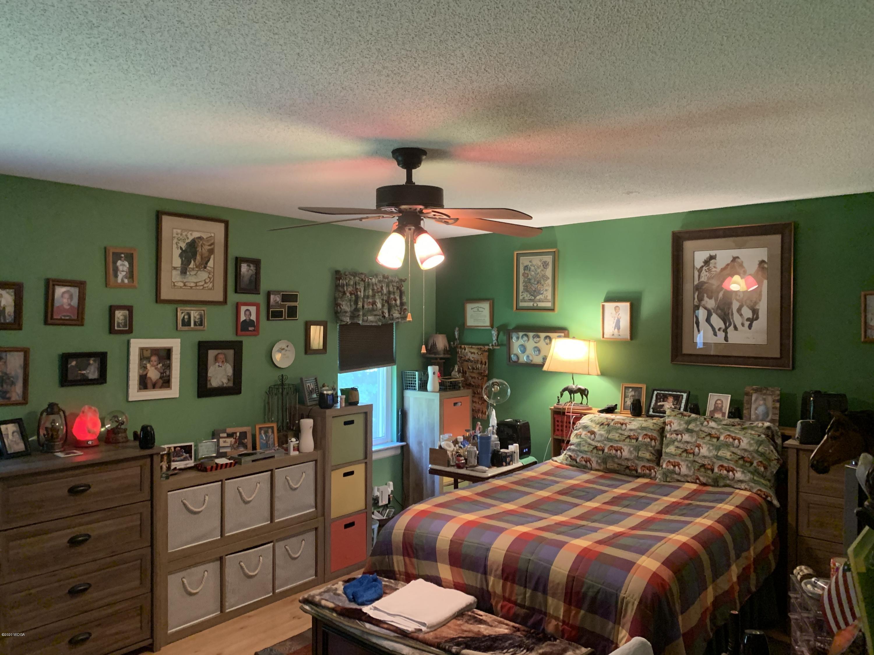 7316 Colaparchee Road Macon, GA 31220 - Photo 7 of 13 a bedroom with bed and wooden floor