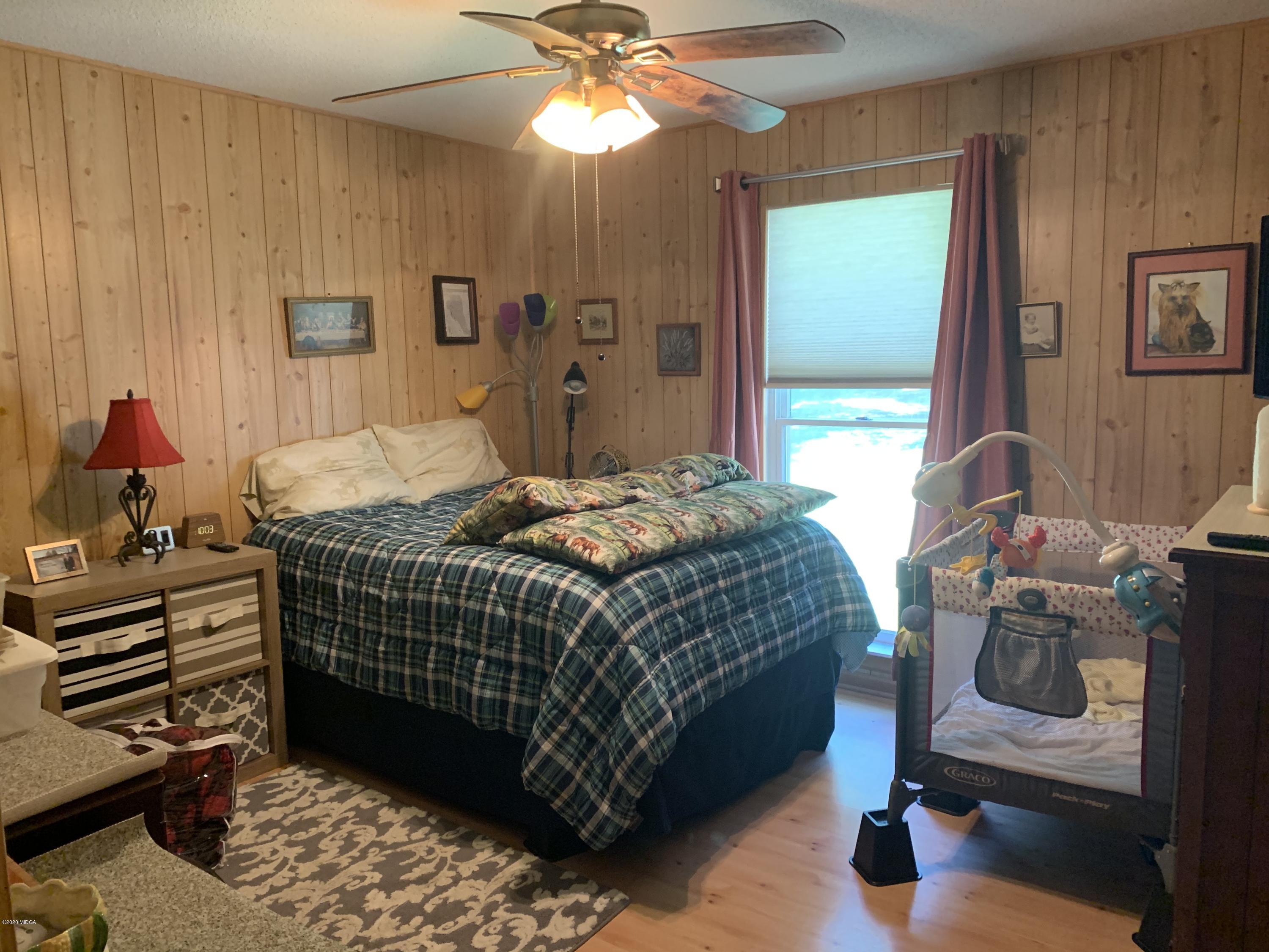7316 Colaparchee Road Macon, GA 31220 - Photo 8 of 13 a bedroom with a bed and a chandelier