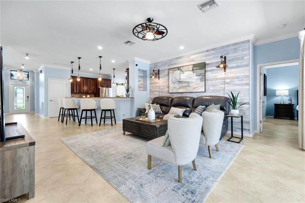 3783 Treasure Cove Circle Naples, FL 34114 - Photo 12 of 43 a living room with furniture and a flat screen tv