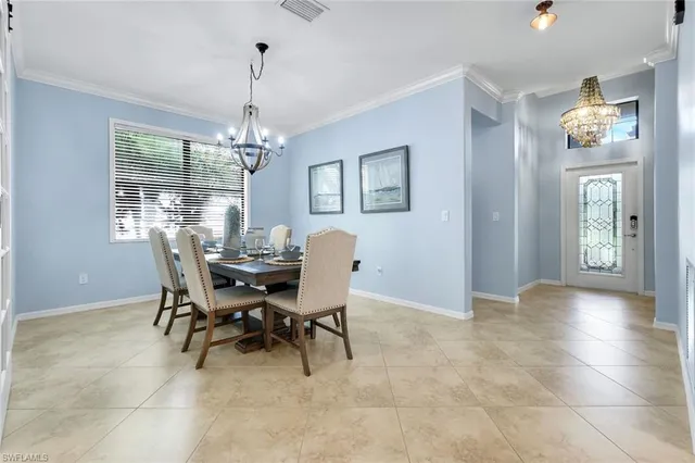 a view of a dining room with furniture wooden floor and chandelier