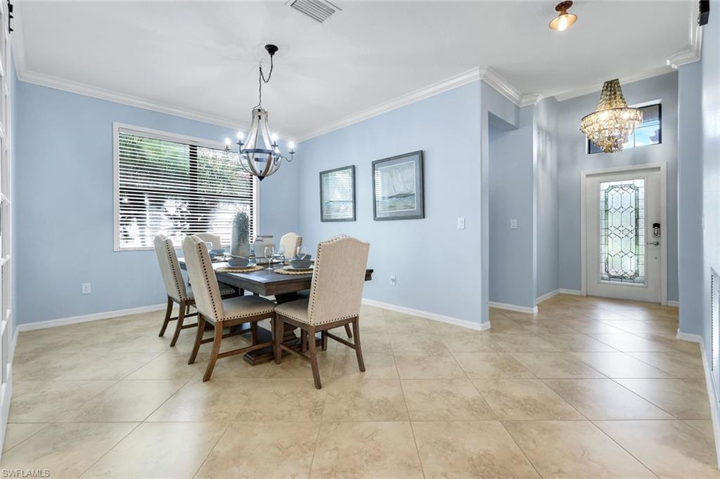 3783 Treasure Cove Circle Naples, FL 34114 - Photo 13 of 43 a view of a dining room with furniture wooden floor and chandelier