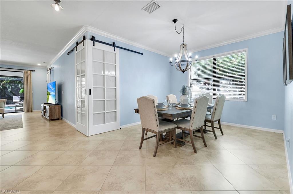 3783 Treasure Cove Circle Naples, FL 34114 - Photo 14 of 43 a view of a dining room with furniture and chandelier