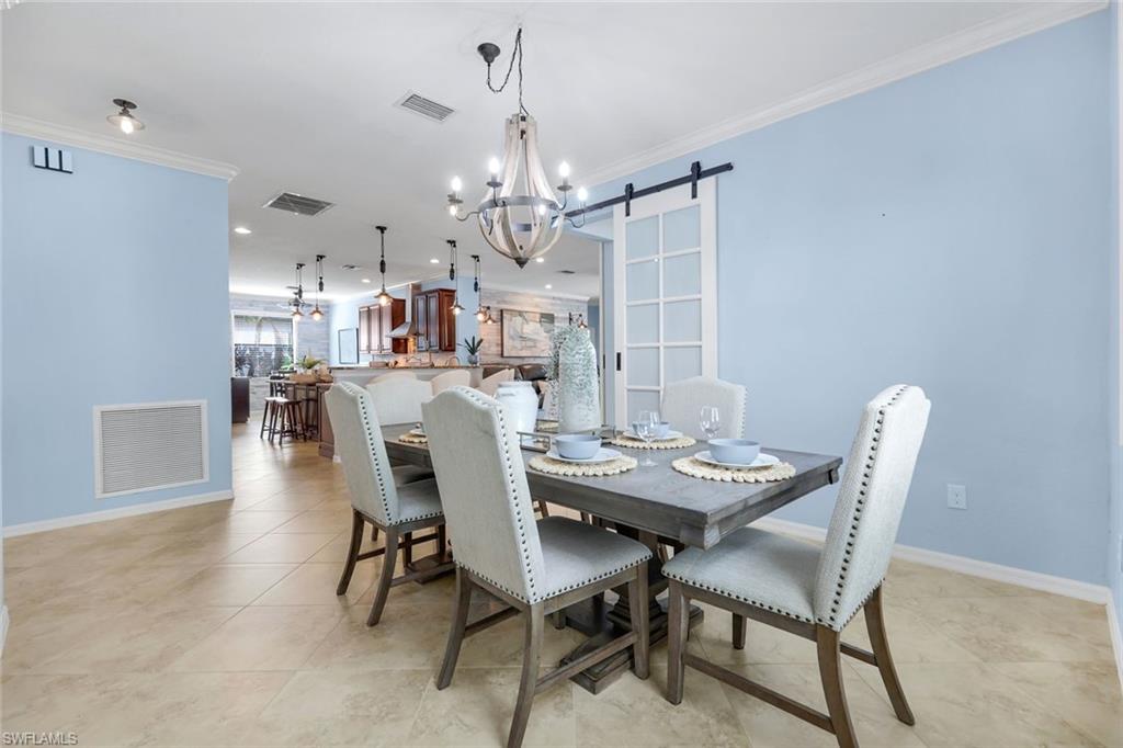 3783 Treasure Cove Circle Naples, FL 34114 - Photo 15 of 43 a view of a dining room with furniture and a chandelier