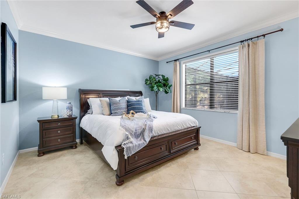 3783 Treasure Cove Circle Naples, FL 34114 - Photo 19 of 43 a bed sitting in a bedroom next to a window