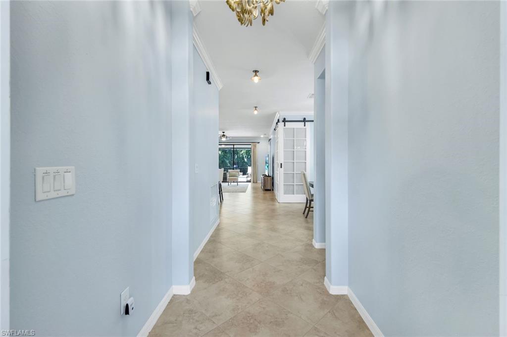 3783 Treasure Cove Circle Naples, FL 34114 - Photo 3 of 43 a view of a hallway with dining area