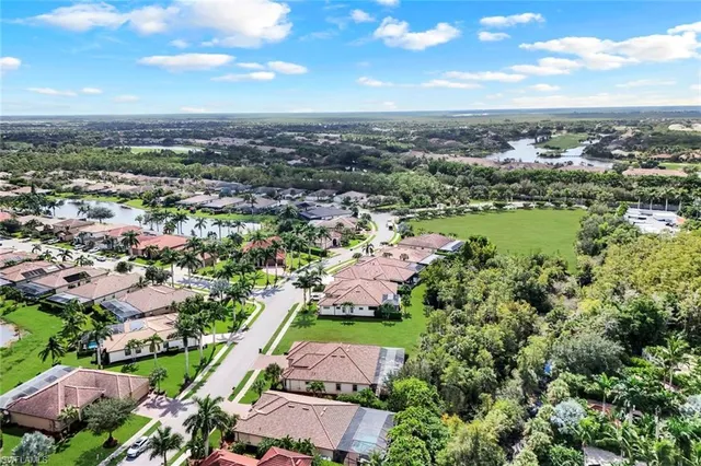 an aerial view of residential houses with outdoor space and street view