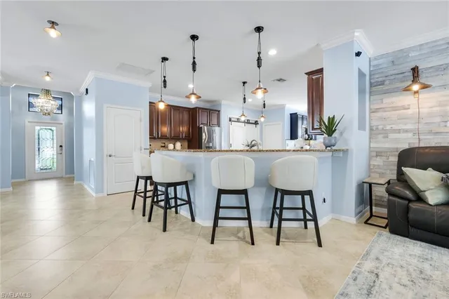 a large kitchen with a table and chairs