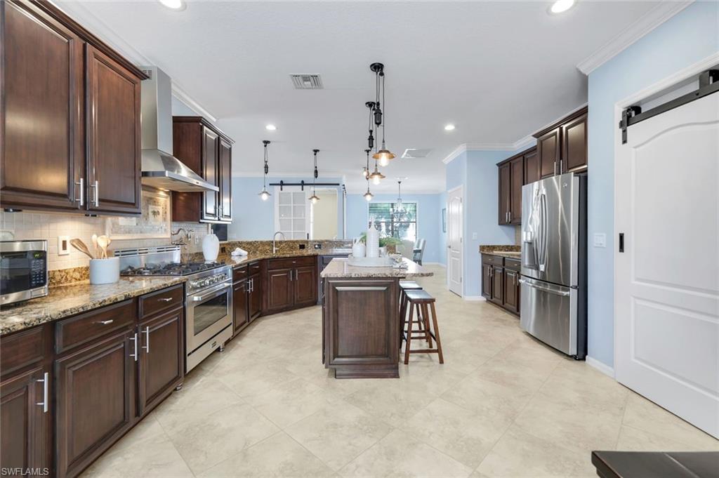 3783 Treasure Cove Circle Naples, FL 34114 - Photo 6 of 43 a large kitchen with stainless steel appliances lots of counter top space