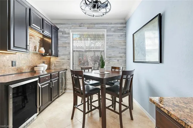 a kitchen with stainless steel appliances granite countertop wooden floor and a window