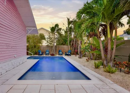 an aerial view of a house with garden space and street view