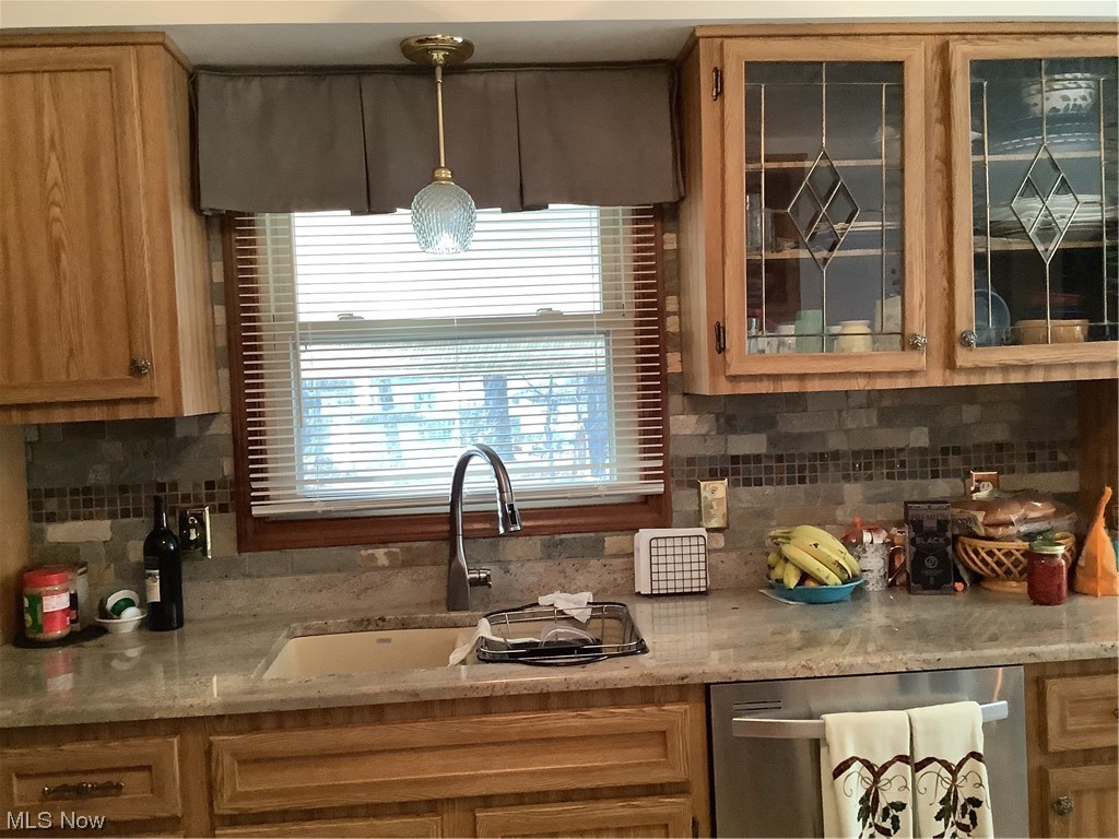 2320 South Meridian Road Austintown, OH 44511 - Photo 5 of 24 Kitchen with hanging light fixtures, dishwasher, sink, tasteful backsplash, and light stone counters