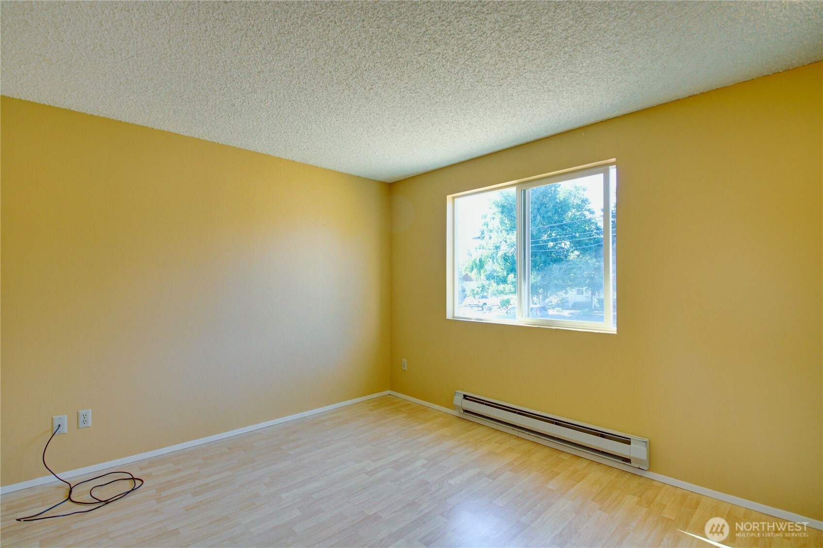 1214 36th Street Anacortes, WA 98221 - Photo 22 of 35 a view of a big room with wooden floor and a window
