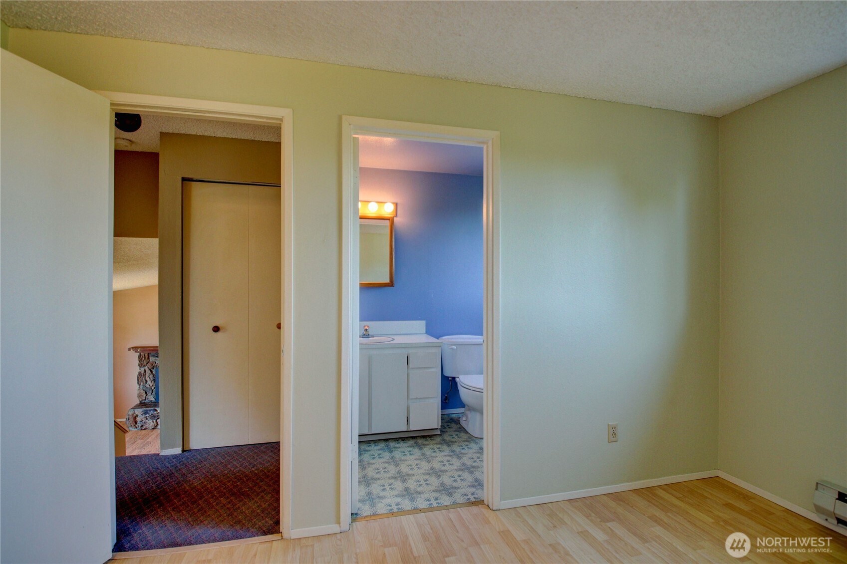 1214 36th Street Anacortes, WA 98221 - Photo 28 of 35 a view of a hallway with wooden floor and cabinet