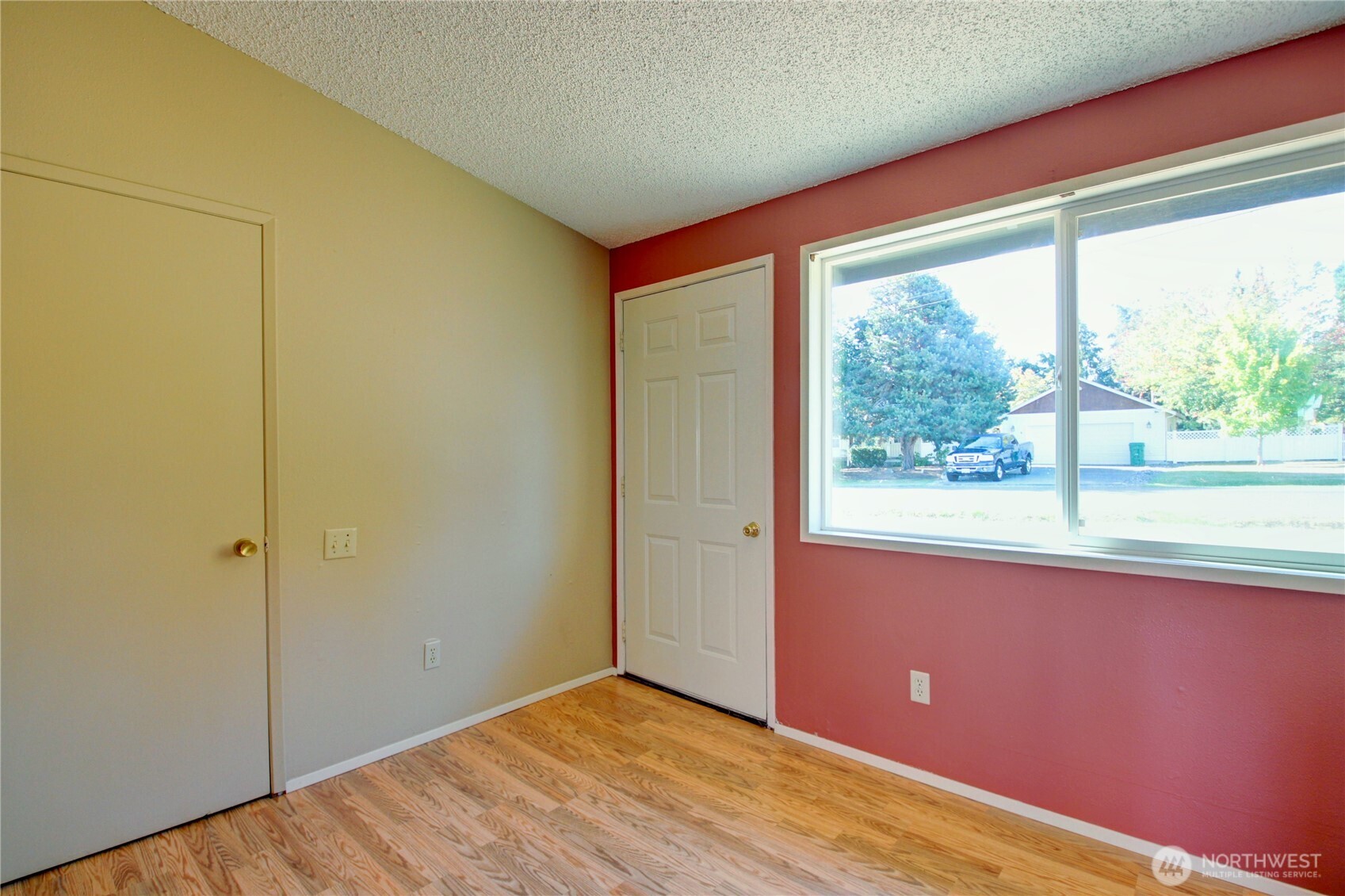 1214 36th Street Anacortes, WA 98221 - Photo 6 of 35 an empty room with wooden floor and windows