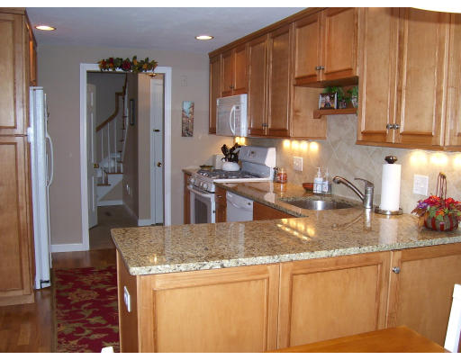 21 Cider Mill Road Framingham, MA 01701 - Photo 7 of 22 a kitchen with stainless steel appliances granite countertop a refrigerator a stove and a sink