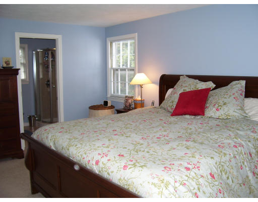 21 Cider Mill Road Framingham, MA 01701 - Photo 8 of 22 a bedroom with a bed and a lamp