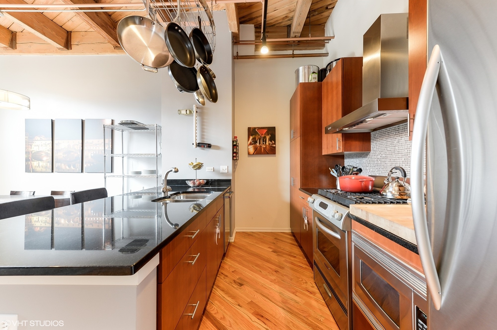 1040 West Adams Street, Unit 428 Chicago, IL 60607 - Photo 14 of 28 a kitchen with stainless steel appliances granite countertop a sink and cabinets