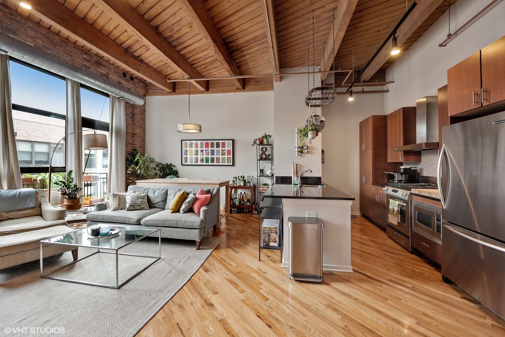 1040 West Adams Street, Unit 428 Chicago, IL 60607 - Photo 15 of 28 a living room with stainless steel appliances kitchen island granite countertop furniture wooden floor and a view of kitchen