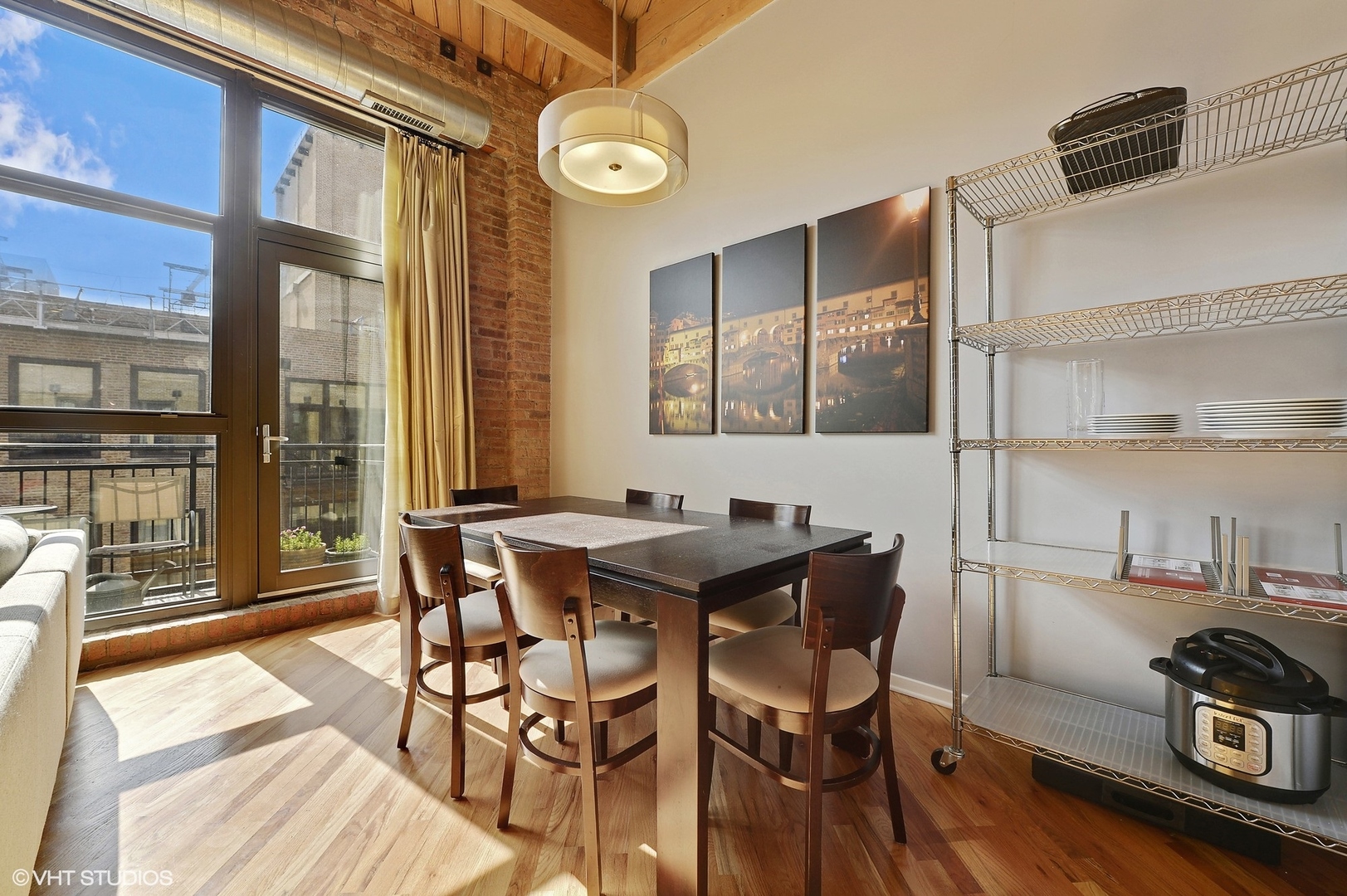 1040 West Adams Street, Unit 428 Chicago, IL 60607 - Photo 16 of 28 a view of a dining room with furniture and wooden floor