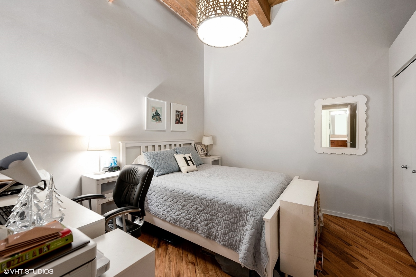 1040 West Adams Street, Unit 428 Chicago, IL 60607 - Photo 22 of 28 a bedroom with a bed and wooden floor