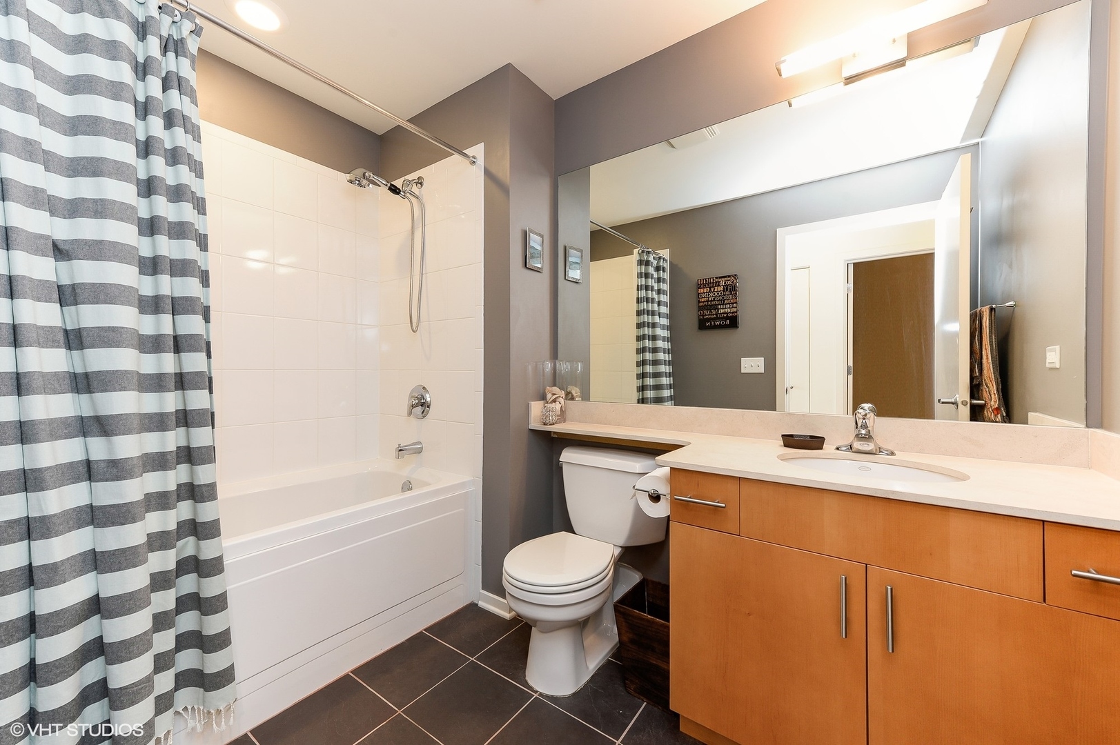 1040 West Adams Street, Unit 428 Chicago, IL 60607 - Photo 23 of 28 a bathroom with a sink toilet a shower and a mirror