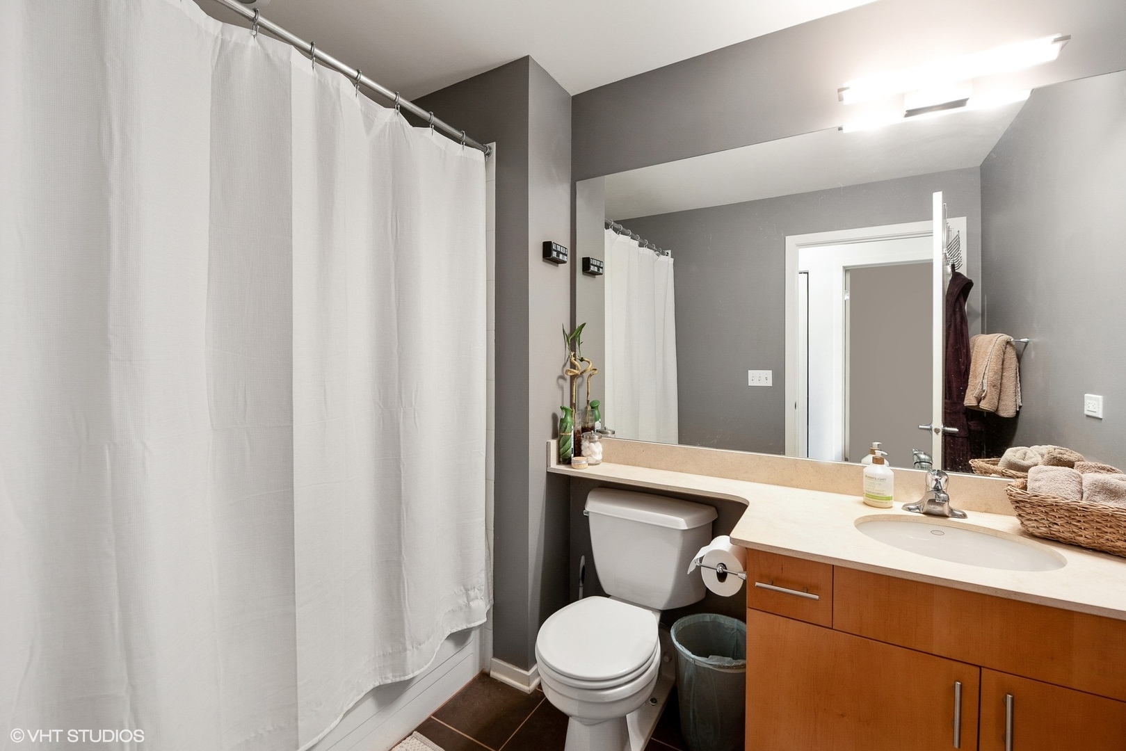 1040 West Adams Street, Unit 428 Chicago, IL 60607 - Photo 24 of 28 a bathroom with a granite countertop sink toilet and a mirror