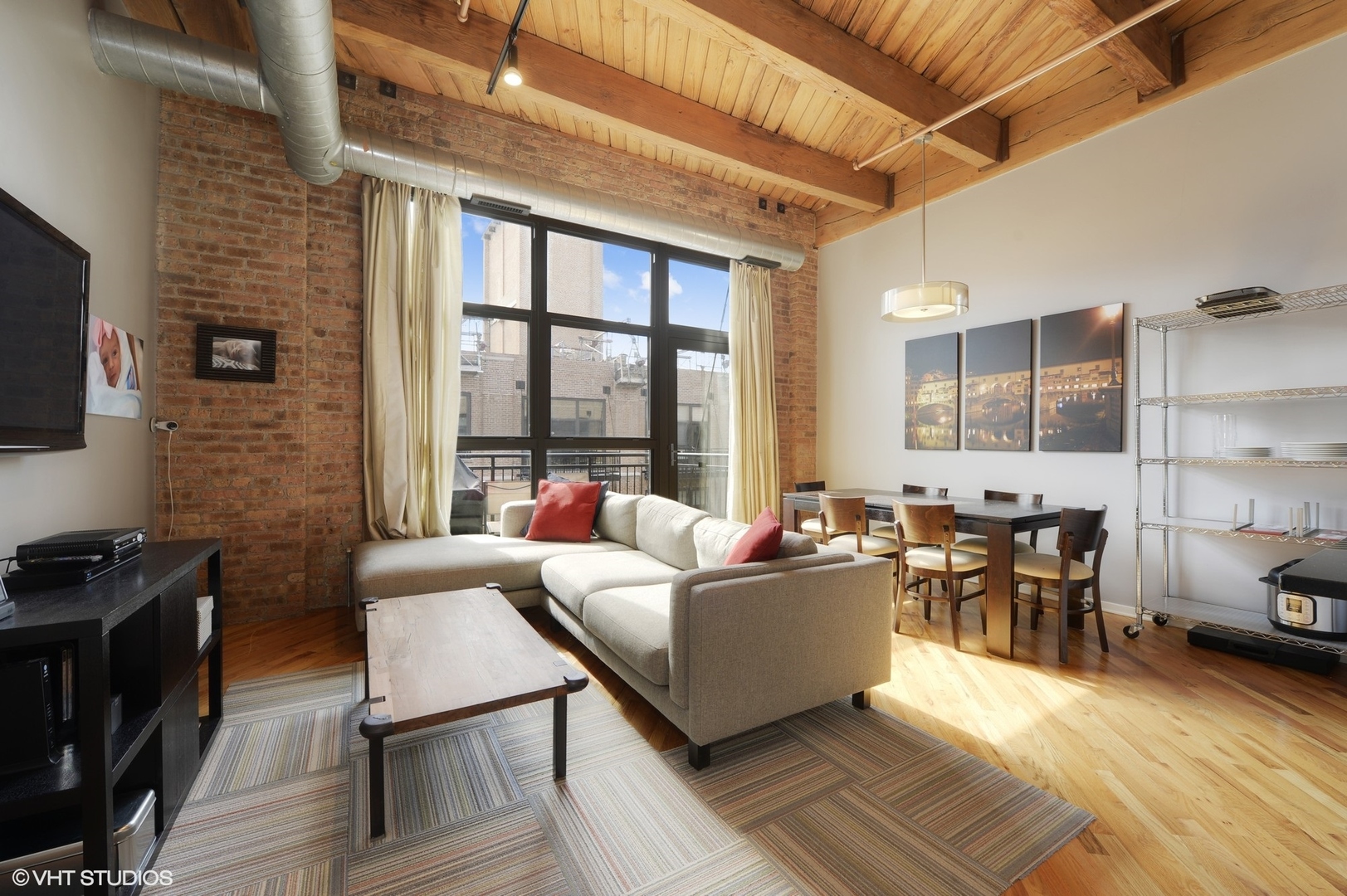 1040 West Adams Street, Unit 428 Chicago, IL 60607 - Photo 10 of 28 a living room with furniture and a flat screen tv