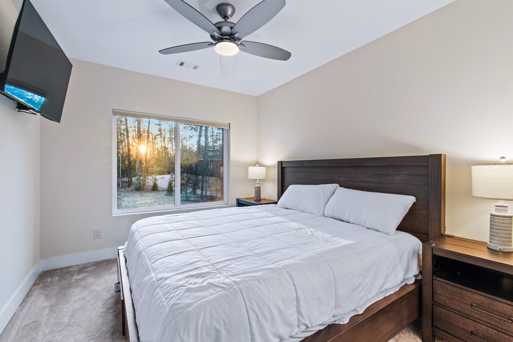 1001 Sunset Road Epworth, GA 30541 - Photo 32 of 36 a bedroom with a bed and a flat tv screen on the dresser