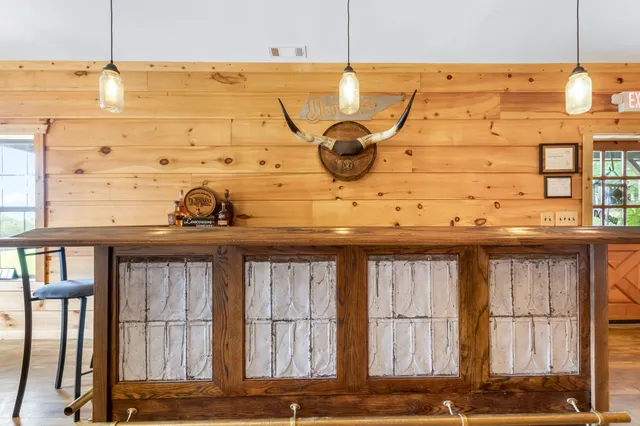 a kitchen with cabinets stainless steel appliances and wooden floor