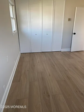 an empty room with wooden floor