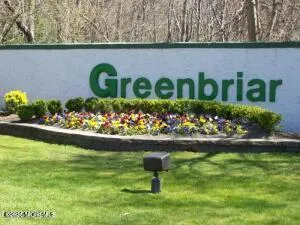 a street sign in front of flowers
