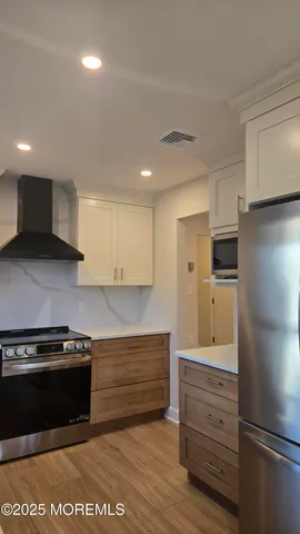 a kitchen with a refrigerator stove and cabinets