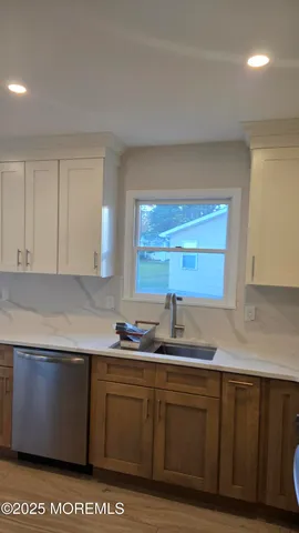 a kitchen with stainless steel appliances granite countertop a sink a stove and cabinets