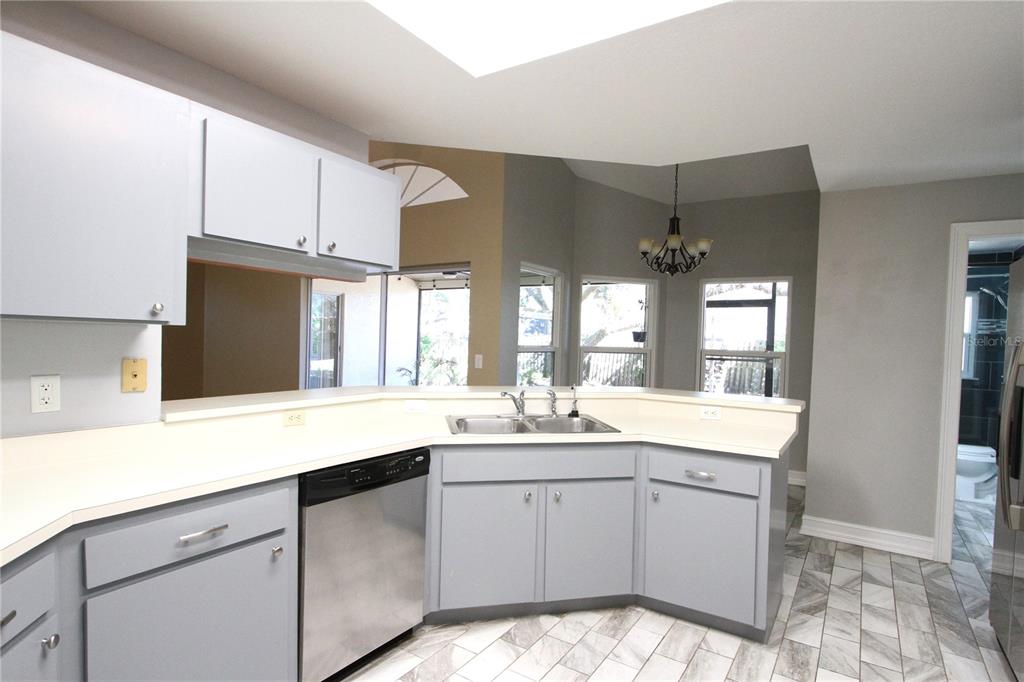 1414 Norwick Drive Lutz, FL 33559 - Photo 9 of 43 a kitchen with a sink stove and cabinets