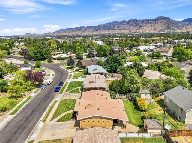 702 North 150 West Logan, UT 84321 - Photo 49 of 51 Residential neighborhood with mature trees, mountain backdrop, and paved streets