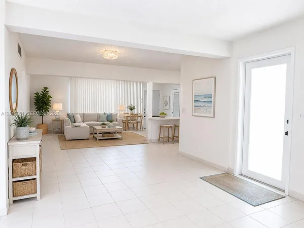 a living room with furniture and a potted plant