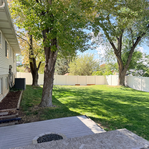 10240 Locksley Road Sandy, UT 84092 - Photo 24 of 27 Expansive backyard featuring a manicured lawn, established trees, and a durable vinyl fence
