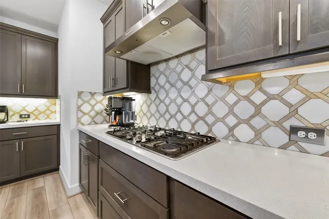 a view of a room with wooden floor and white walls