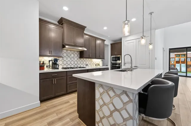 a view of a room with wooden floor and furniture