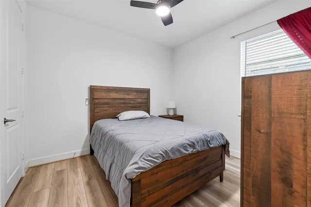 a bedroom with a bed and a large window