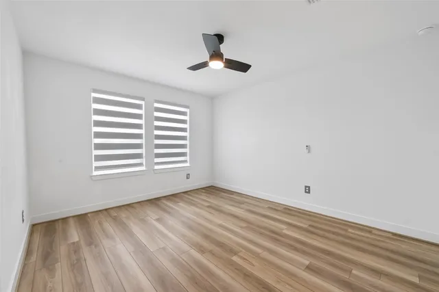 a view of a patio with table and chairs and a barbeque