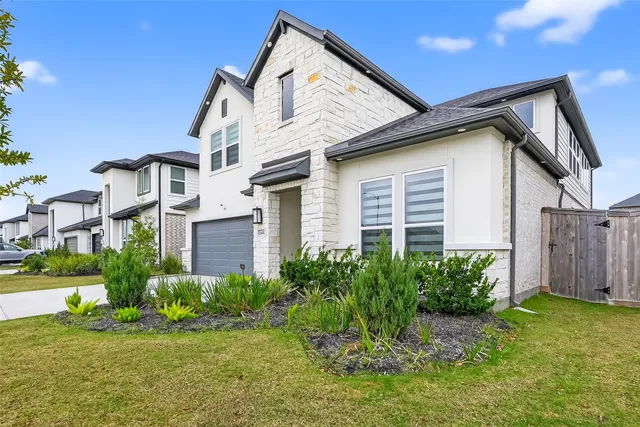 a living room with furniture a window and wooden floor
