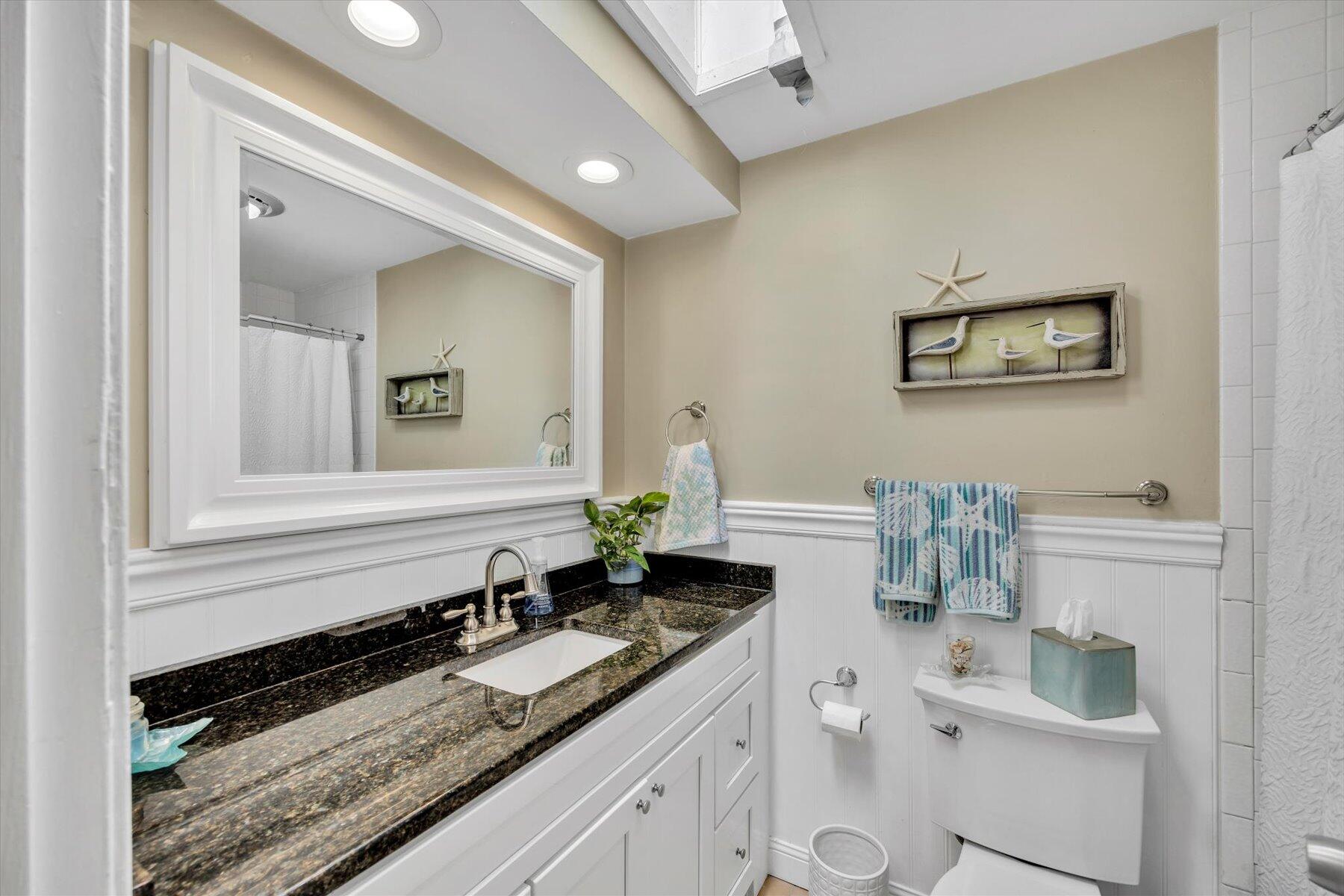 30 Guildford Road Centerville, MA 02632 - Photo 31 of 42 a bathroom with a granite countertop sink and a mirror
