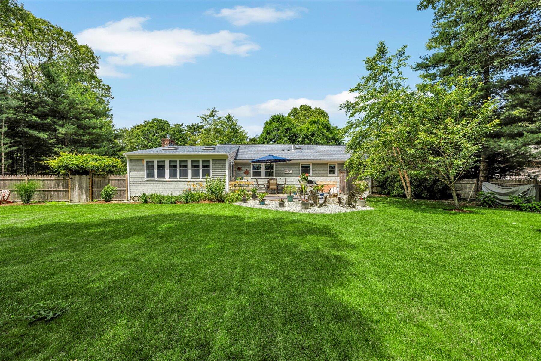 30 Guildford Road Centerville, MA 02632 - Photo 5 of 42 a view of a house with a yard table and chairs