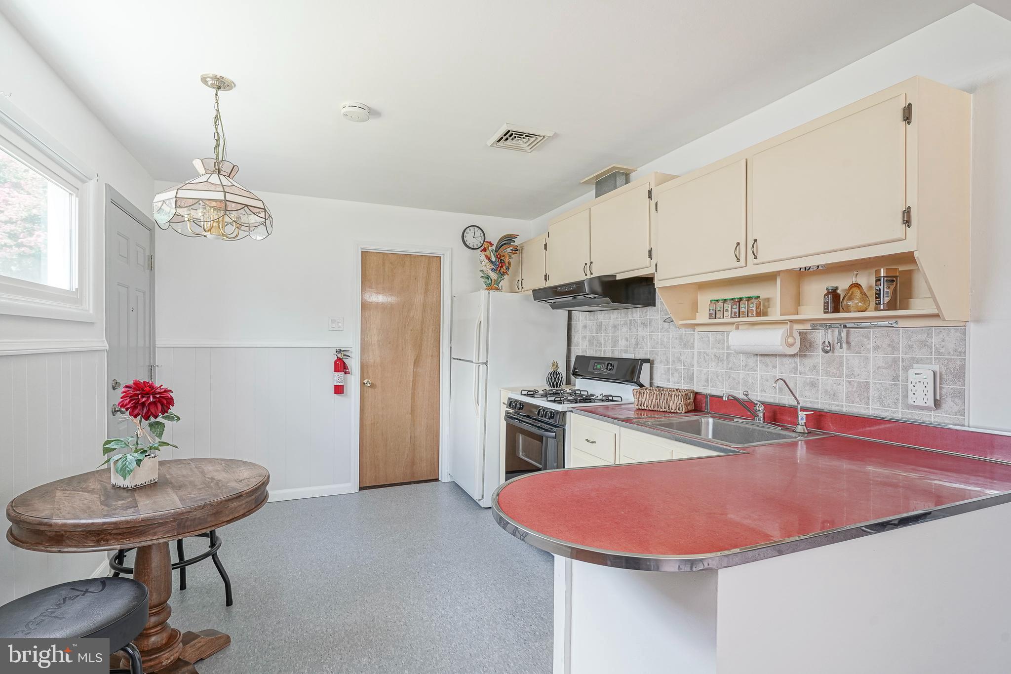 419 Ruth Avenue Maple Shade, NJ 08052 - Photo 13 of 28 a kitchen with stainless steel appliances kitchen island granite countertop a sink dishwasher and a refrigerator with wooden floor