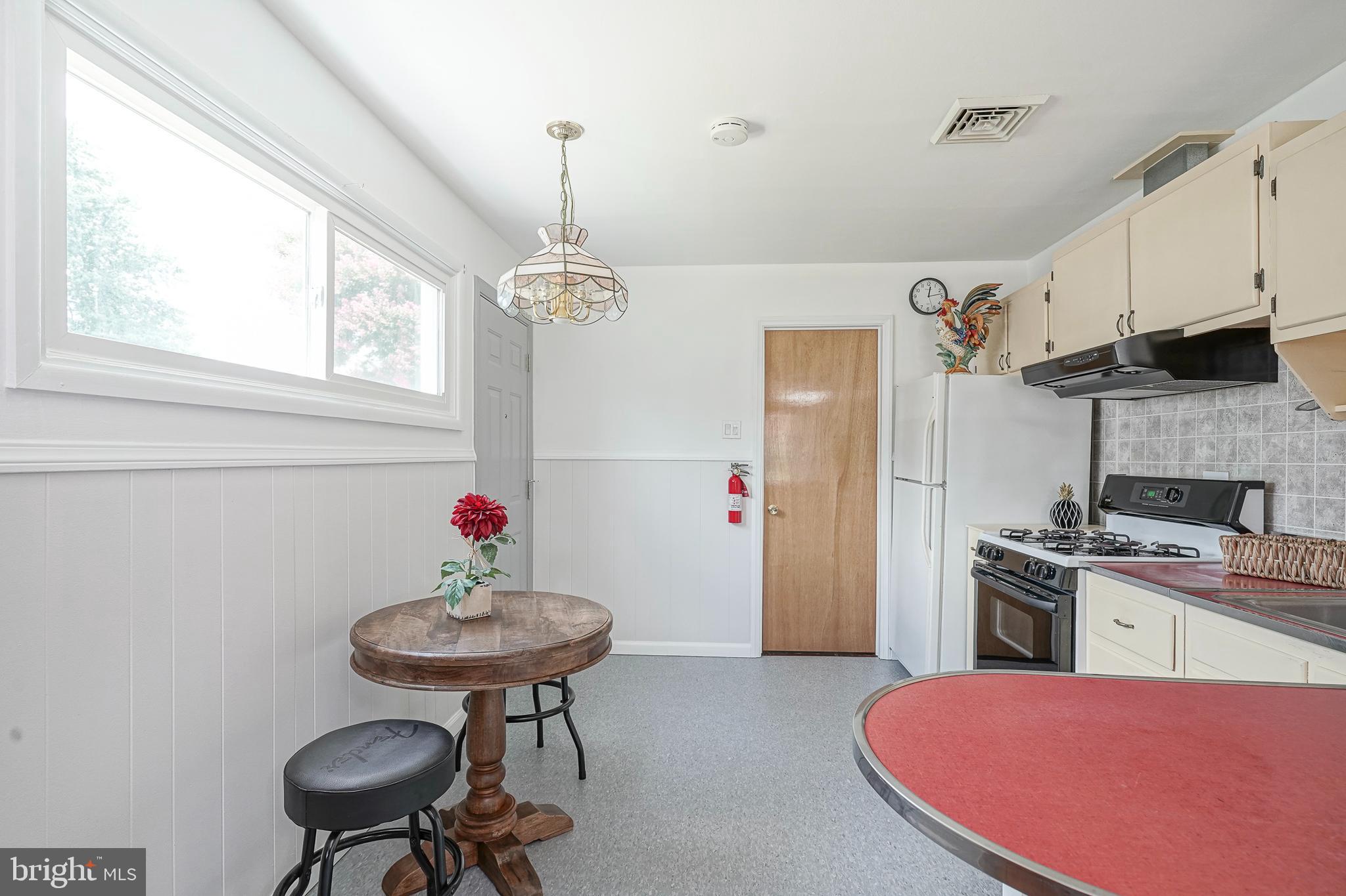 419 Ruth Avenue Maple Shade, NJ 08052 - Photo 14 of 28 a kitchen with stainless steel appliances a sink a stove a refrigerator dining table and chairs