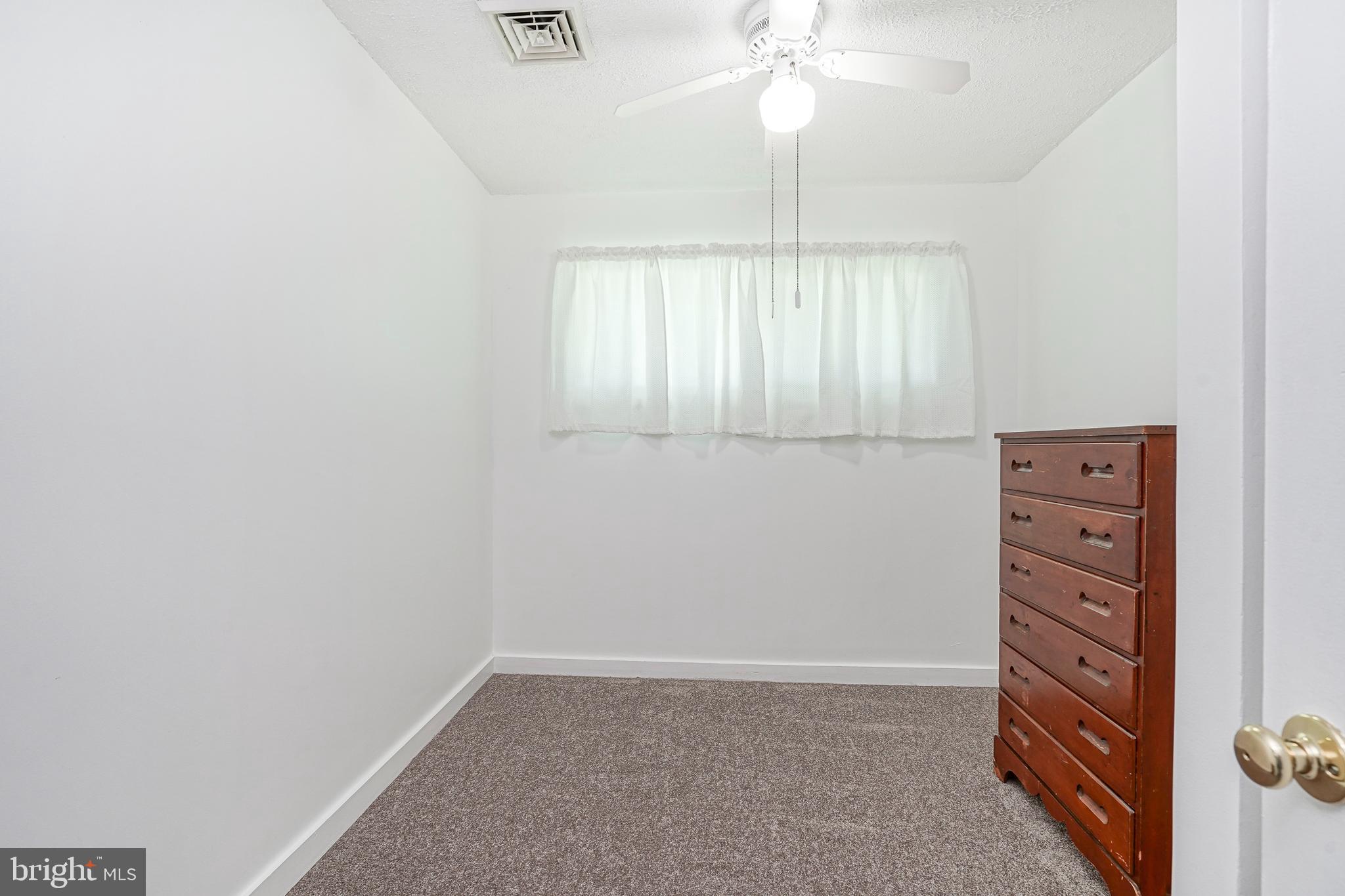 419 Ruth Avenue Maple Shade, NJ 08052 - Photo 16 of 28 an empty room with windows and fan