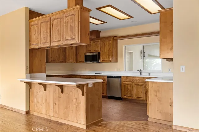 a kitchen with stainless steel appliances a stove a microwave and cabinets